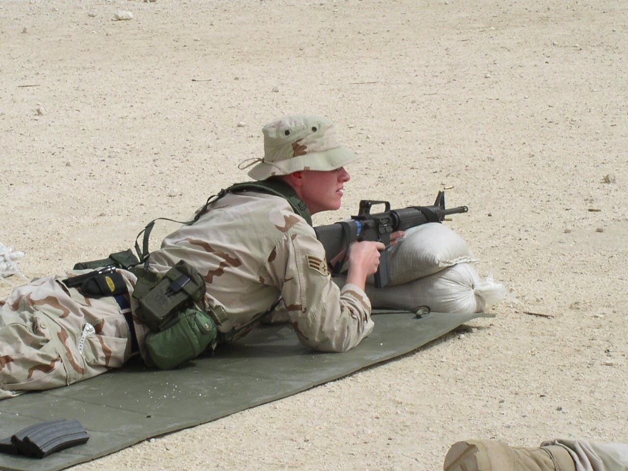 Weapons qualification in Qatar in 2002; two men on camels walked across the active firing range